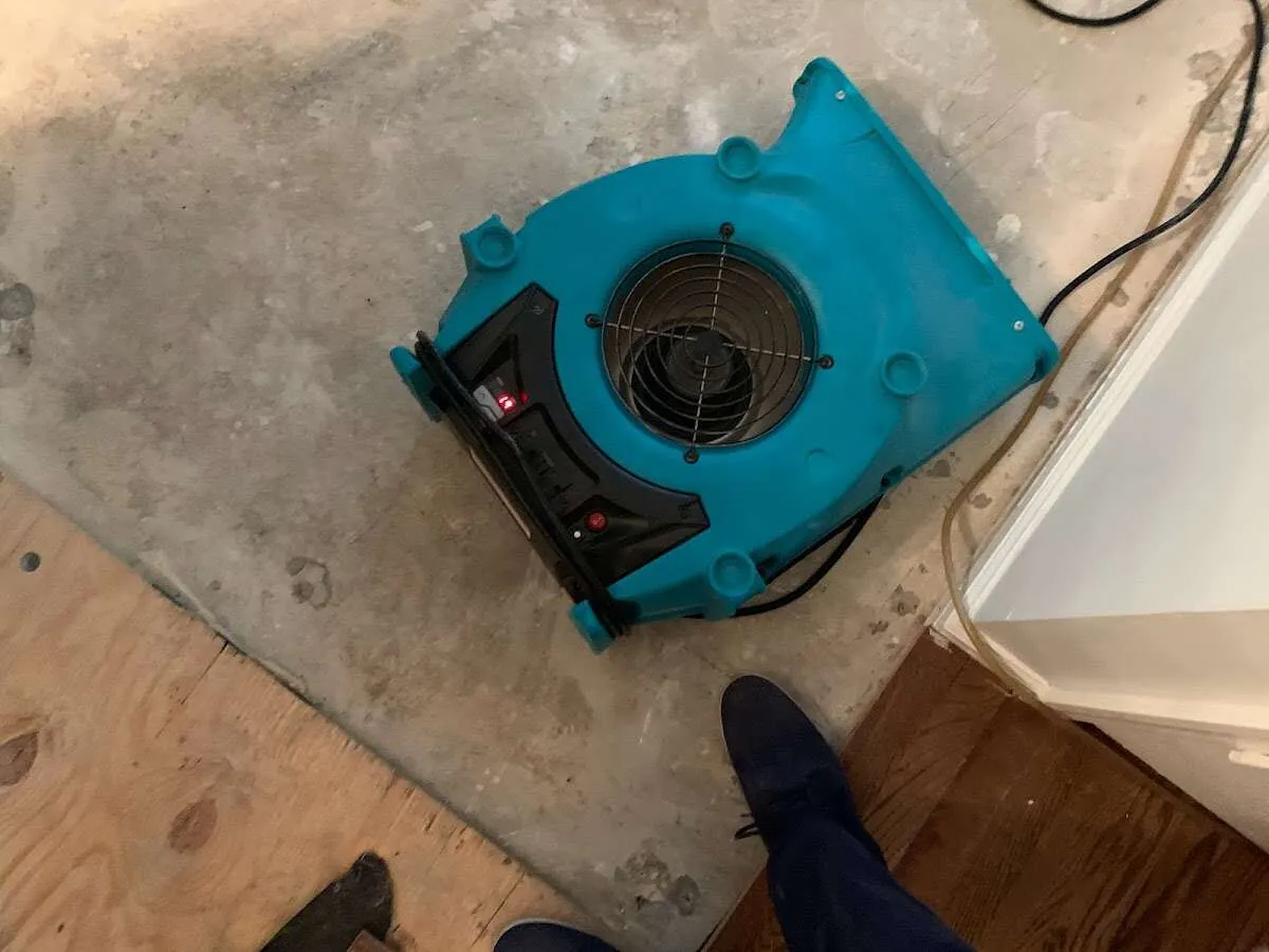 Air mover drying subfloor during Commercial Water Damage Restoration in Lancaster